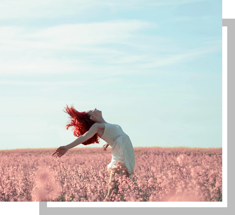 A woman in white dress jumping in the air.