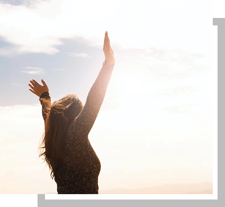 A woman with her arms raised in the air.